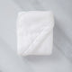 Folded Baby Hooded Towel in white, flat lay shot with marble background