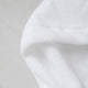 Baby hooded towel in white, detail shot from zero-twist cotton wit marble background